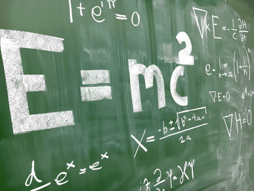 Physics formulas on a chalkboard